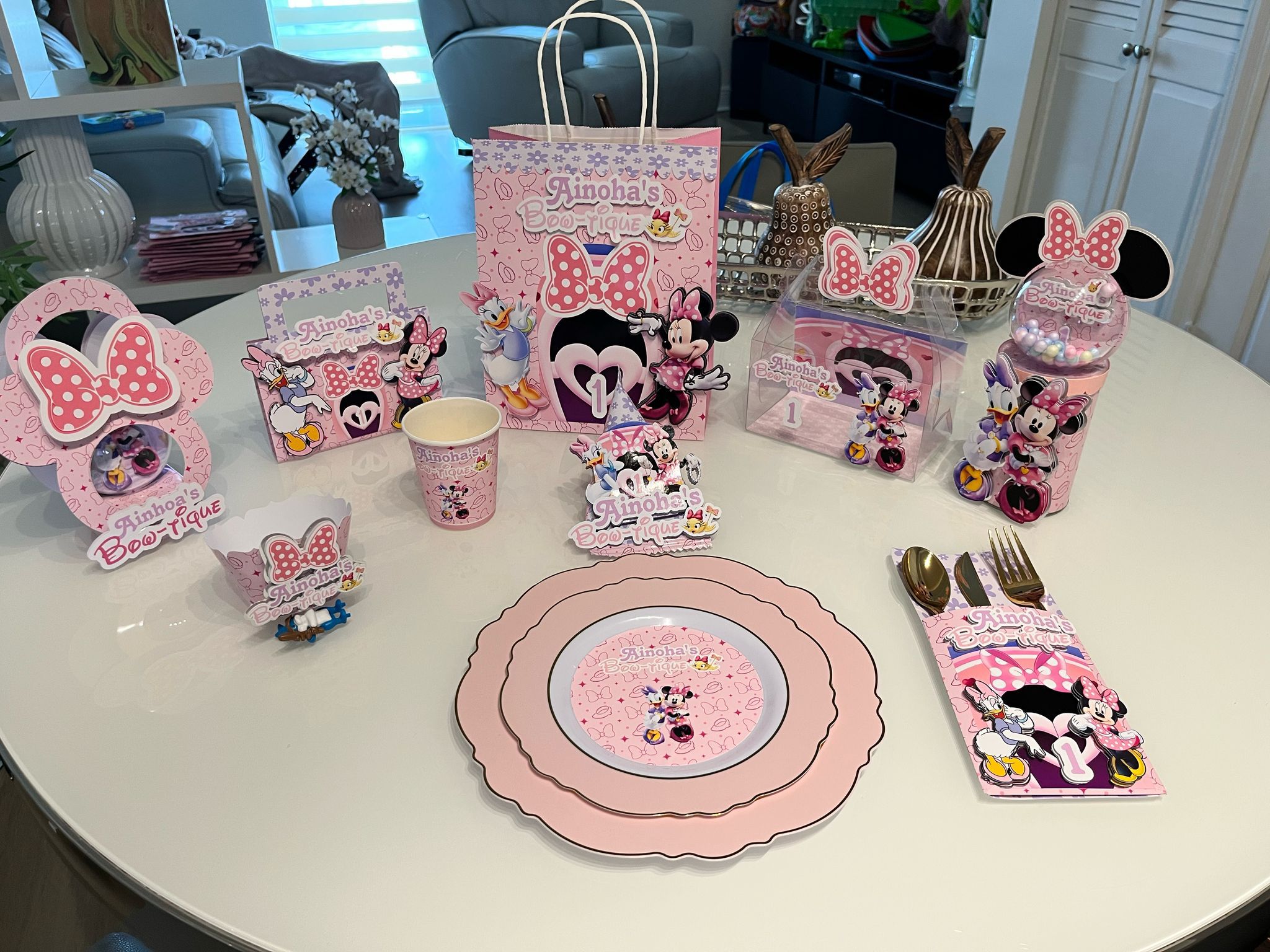 Complete Minnie Mouse themed party set with plates, cups, favors and centerpiece